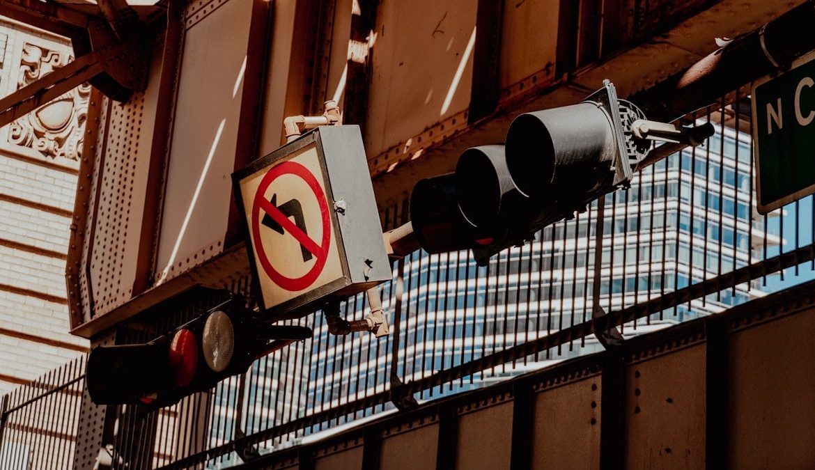 A traffic light hanging from the side of a building