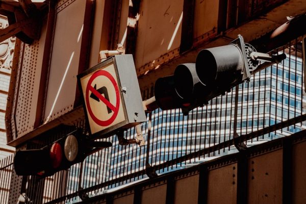 A traffic light hanging from the side of a building