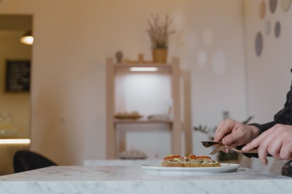 A man enjoying a healthy vegan meal in a cozy indoor cafe setting.